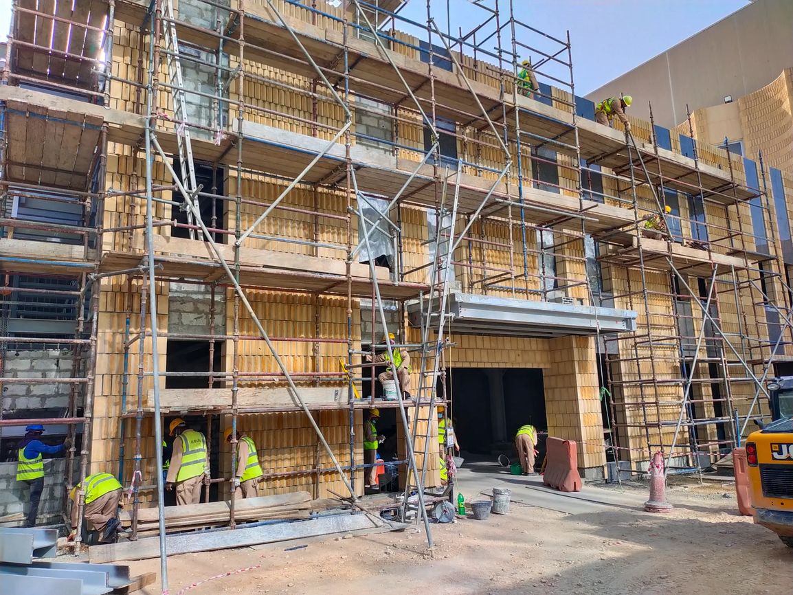 Facade installation in progress with Riyadh stone